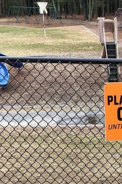 This Friday, March 20, 2020 file photo shows a closed sign near an entrance to a playground