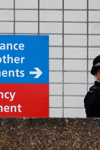 Police officers patrol outside a hospital where Britain's Prime Minister Boris Johnson is believed to be undergoing tests after suffering from coronavirus symptoms, in London, April 6, 2020.