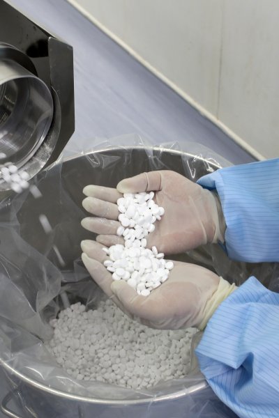 a pharmaceutical manufacturer employee checks the production of chloroquine phosphate