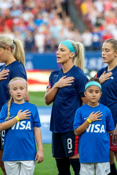 United States players Tierna Davidson, Lindsey Horan, Julie Ertz, Abby Dahlkemper, and Kelley O'Hara stand with their jerseys turned inside out during the playing of the national anthem before a SheBelieves Cup women's soccer match against Japan, Wednesday, March 11, 2020 at Toyota Stadium in Frisco, Texas.