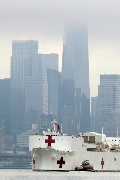 The Navy hospital ship USNS Comfort passes lower Manhattan on its way to docking in New York, Monday, March 30, 2020.