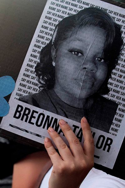 A demonstrator in Denver, Colorado, holds a sign with the image of Breonna Taylor, a Black woman who was fatally shot by Louisville Metro Police Department officers, during a protest against police brutality, June 3, 2020.