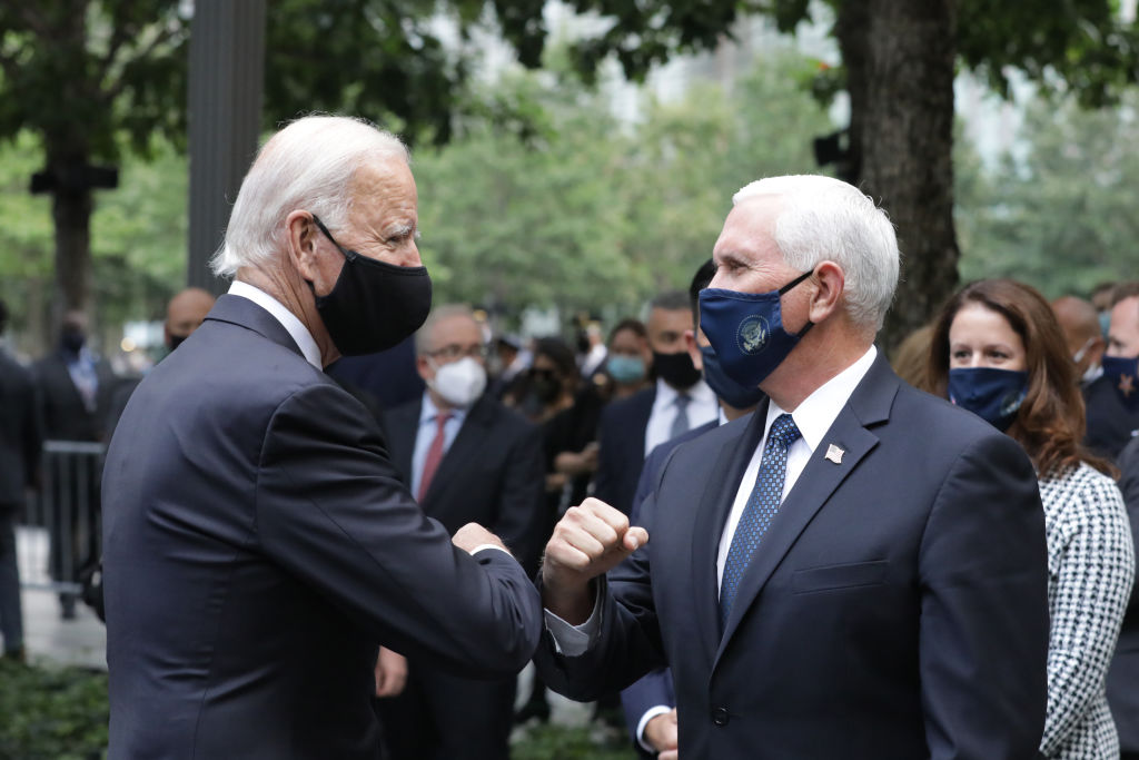 Democratic presidential nominee Joe Biden (L) and U.S. Vice President Mike Pence (R) greet each other during a 9/11 memorial service at the National September 11 Memorial and Museum on September 11, 2020 in New York City.