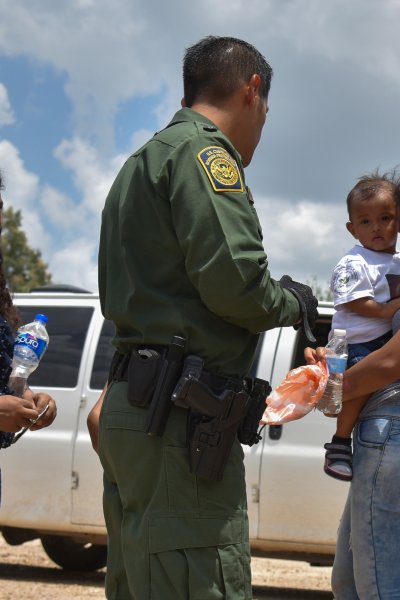 In this file photo, two young mothers from Honduras, L and R, and their respective children - a 12-year-old, blocked, and 1-year-old - are detained by United States Border Patrol after rafting across the Rio Grande on the U.S.-Mexico border on Monday, June 25, 2018, in Granjeno, TX.