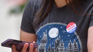 A woman wears an "I VOTE STICKER" after casting her early voting ballot at the City Hall satellite polling station on October 27, 2020 in Philadelphia, Pennsylvania.