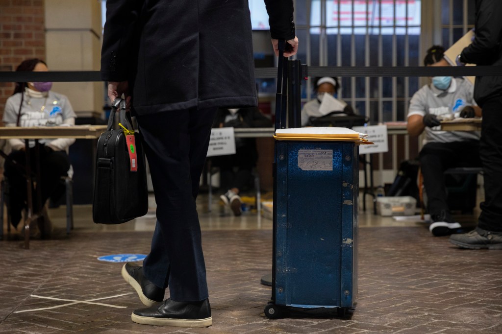 An election worker waits to secure ballots at Ford Field on November 3, 2020 in Detroit, Michigan.