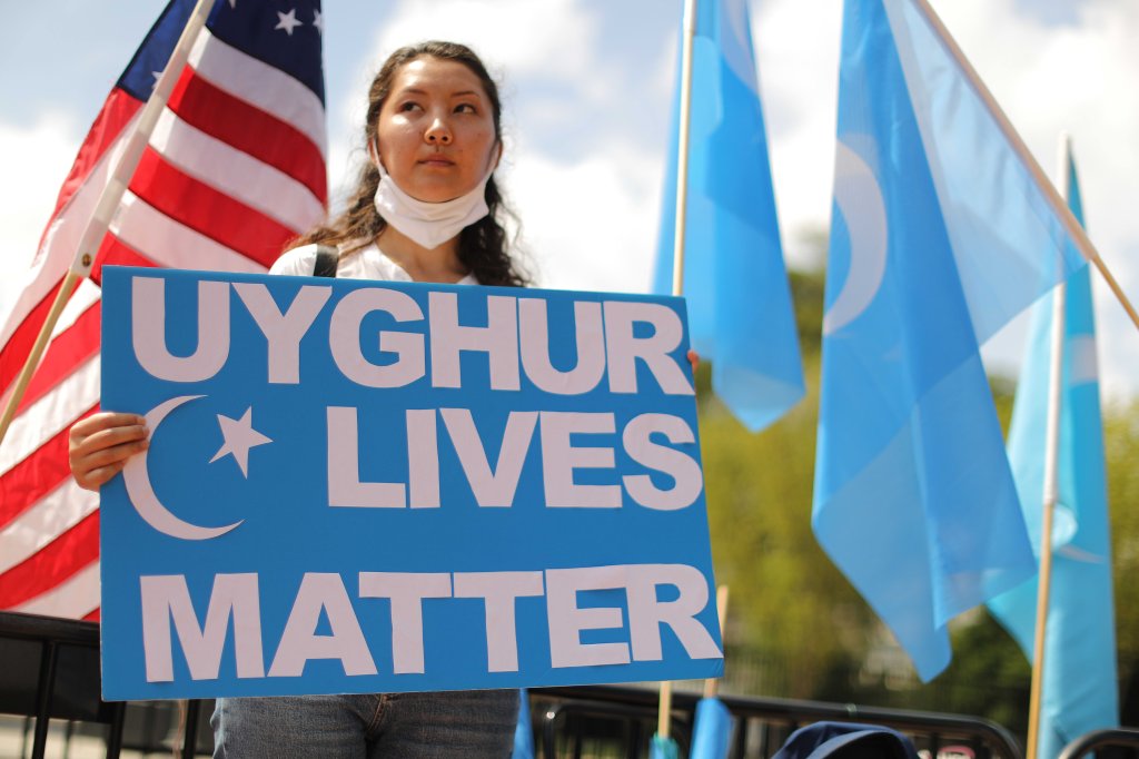 A protester outside the White House urges the United States to take action to stop the oppression of the Uyghur