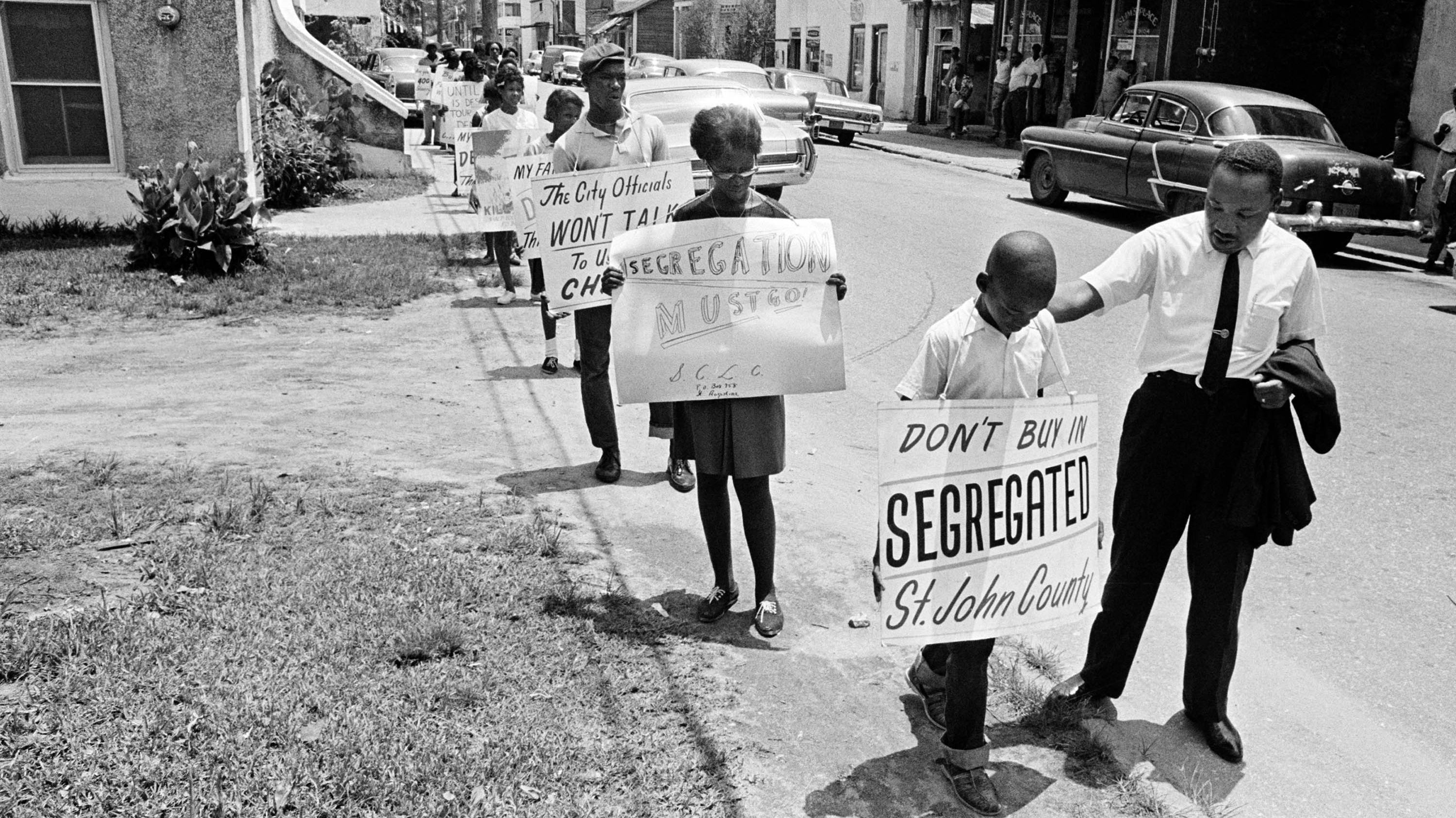 Dr. Martin Luther King, Jr. gives a young picketer a pat on the back as a group of youngsters started to picket St. Augustine, Florida, June 10, 1964.  