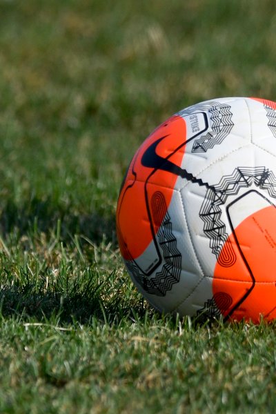 A soccer ball sits on a grass field