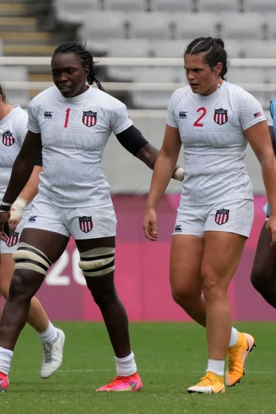 United States players, from left, Lauren Doyle, Kristi Kirshe, Cheta Emba, Ilona Maher, walk off the pitch after defeating China in their women's rugby sevens match