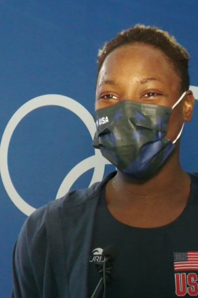 Team USA water polo goalkeeper Ashleigh Johnson smiles under her mask