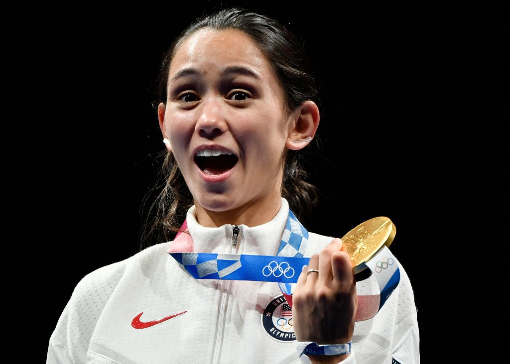 Gold medallist USA's Lee Kiefer celebrate on podium during the medal ceremony for the women's foil individual during the Tokyo 2020 Olympic Games at the Makuhari Messe Hall in Chiba City, Chiba Prefecture, Japan, on July 25, 2021.
