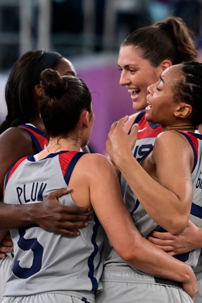 USA's teammates celebrate after wining at the end of the women's semi final 3x3 basketball match between US and France