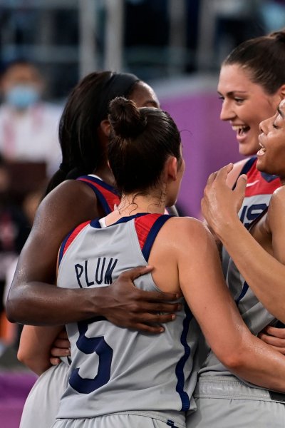 USA's teammates celebrate after wining at the end of the women's semi final 3x3 basketball match between US and France