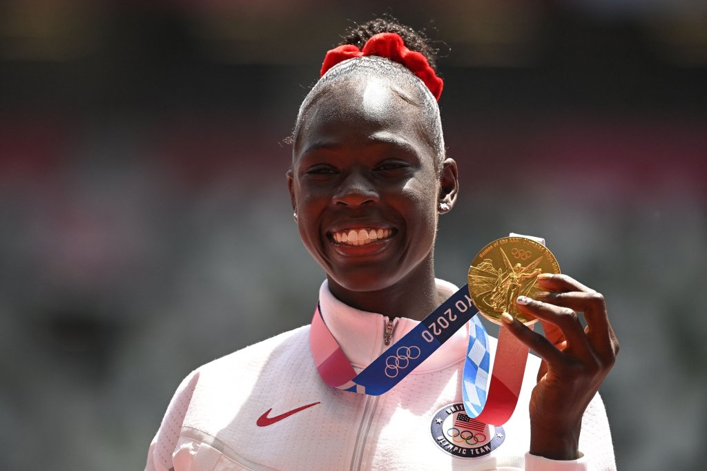 First-placed USA's Athing Mu celebrates on the podium with the gold medal after competing in the women's 800m event during the Tokyo 2020 Olympic Games at the Olympic Stadium in Tokyo on August 4, 2021.