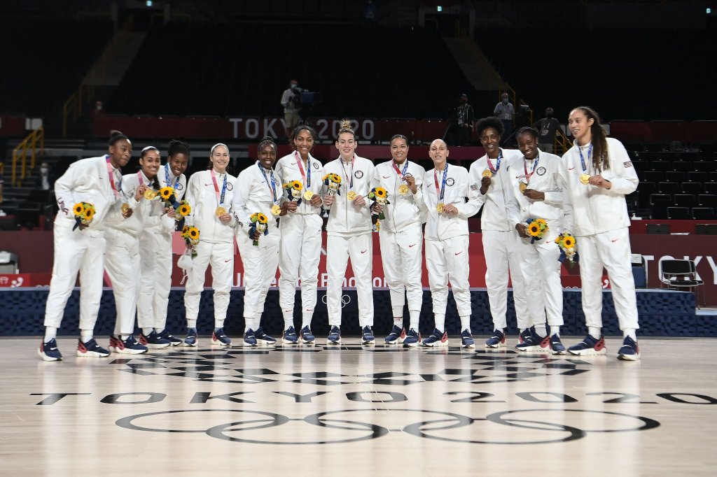 First placed USA's players pose for pictures with their gold medals after the medal ceremony for the women's basketball competition of the Tokyo 2020 Olympic Games at the Saitama Super Arena in Saitama on Aug. 8, 2021.