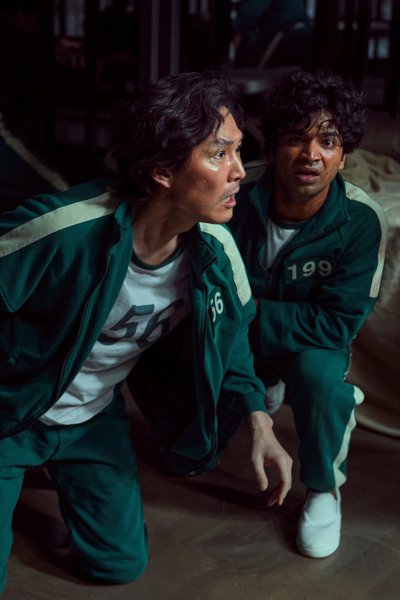 This undated photo released by Netflix shows South Korean cast members, from left, Park Hae-soo, Lee Jung-jae and Anupam Tripathi in a scene from "Squid Game."