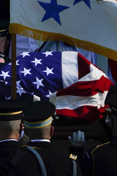 The flag-draped casket of former Secretary of State Colin Powell is carried into the Washington National Cathedral
