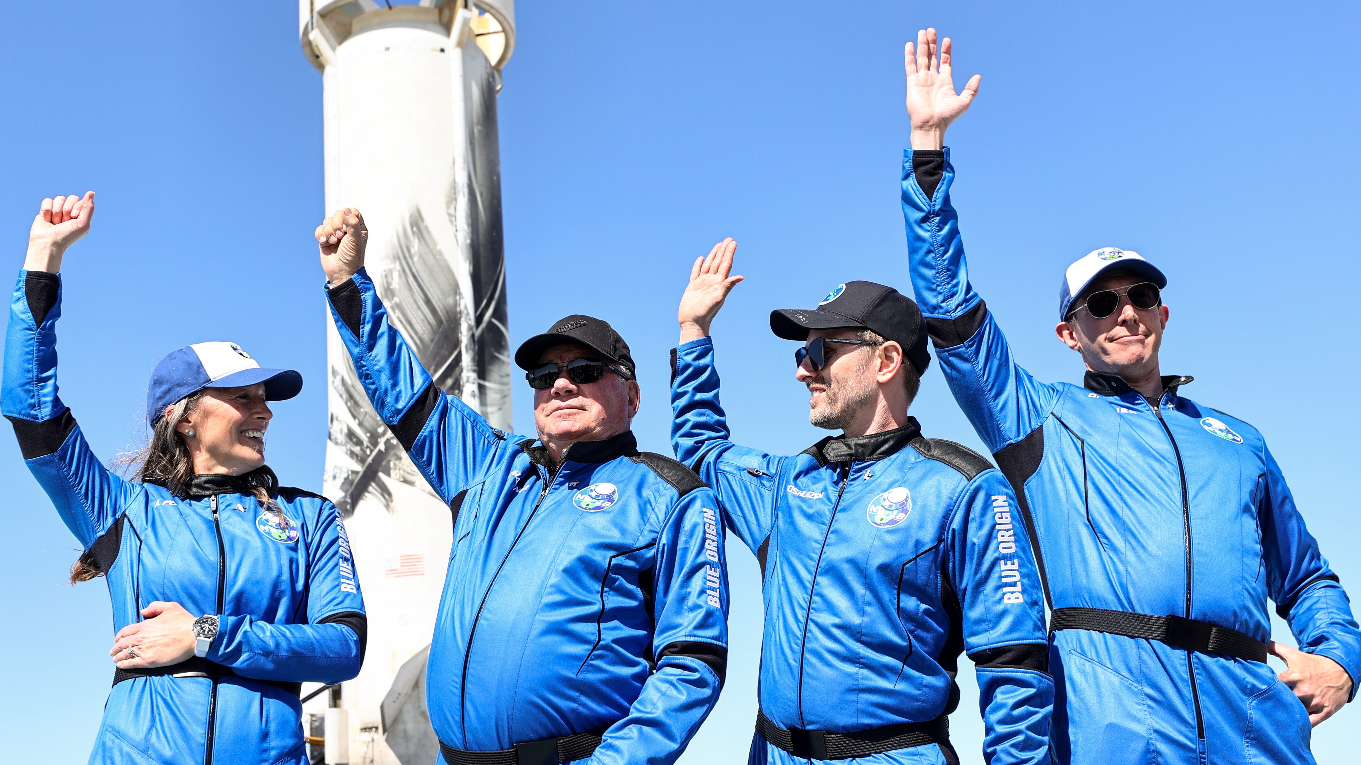 Blue Origin vice president of mission and flight operations Audrey Powers, Star Trek actor William Shatner, Planet Labs co-founder Chris Boshuizen and Medidata Solutions co-founder Glen de Vries wave during a media availability on the landing pad of Blue Origin’s New Shepard after they flew into space on Oct. 13, 2021 near Van Horn, Texas. Shatner became the oldest person to fly into space on the ten minute flight.