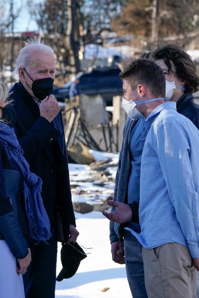 President Joe Biden and first lady Jill Biden talk with people as they tour a neighborhood in Louisville, Colo., Friday, Jan. 7, 2022, that was impacted by the recent wildfire.