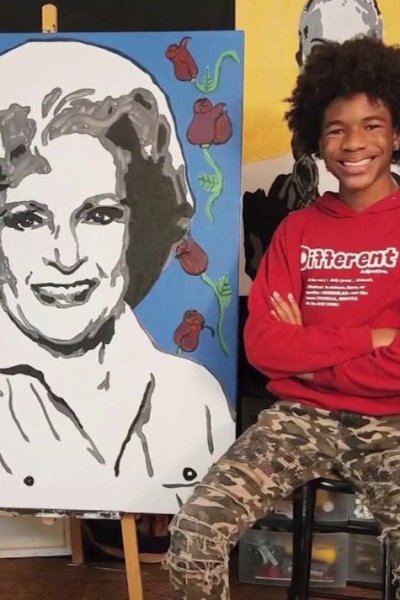 two pictures of smiling teenage boy standing next to paintings of Betty White, Kamala Harris