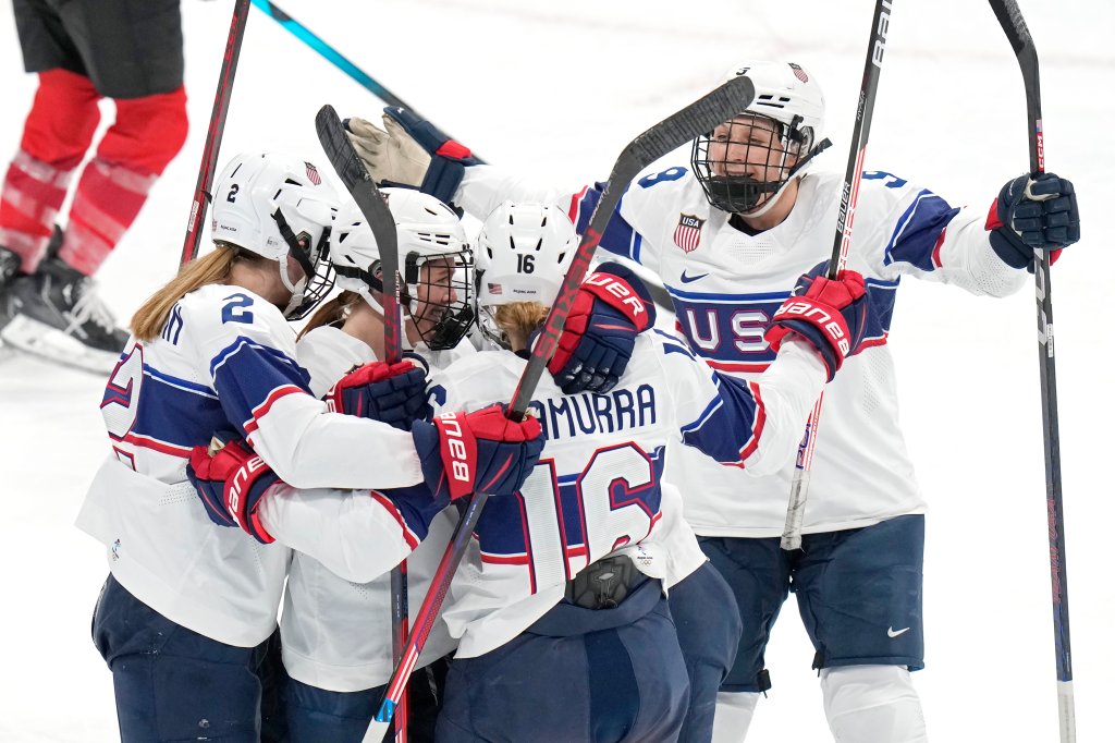 United States players celebrate a goal scored against Switzerland, Feb. 6, 2022, in Beijing. Team USA kept their winning streak strong, routing Switzerland 7 to 0.