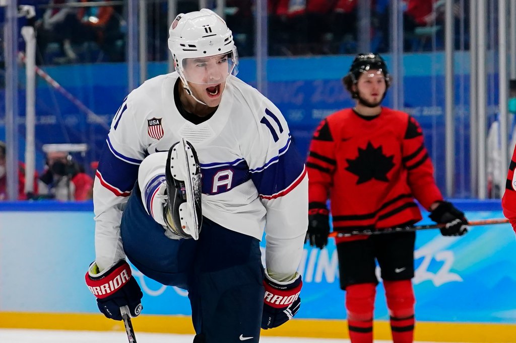 United States' Kenny Agostino (11) celebrates after scoring a goal against Canada during a preliminary round men's hockey game at the 2022 Winter Olympics, Feb. 12, 2022, in Beijing.