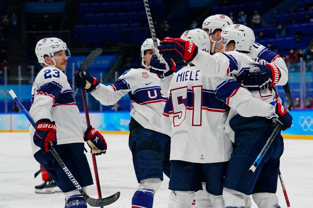 United States players celebrate after a goal by Kenny Agostino during a preliminary round men's hockey game against Canada at the 2022 Winter Olympics, Feb. 12, 2022, in Beijing.