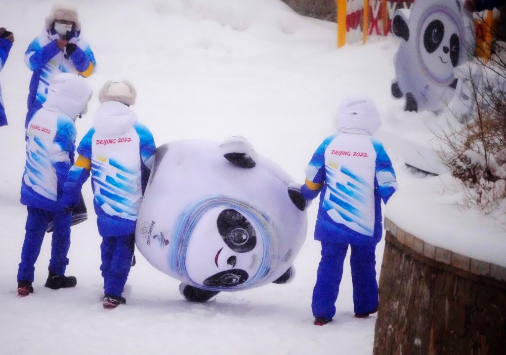 Volunteers carry an inflatable of Bing Dwen Dwen, the mascot of the 2022 Winter Olympics, at the sliding center, Feb. 13, 2022, in the Yanqing district of Beijing, China.