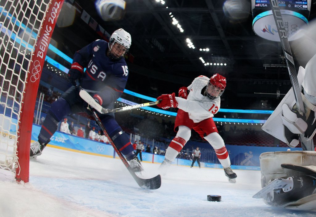 USA's Savannah Harmon, left, scores a goal past Russian Olympic Committee's goaltender Mariia Sorokina during the women's preliminary match for women's ice hockey at the Wukesong Sports Centre in Beijing, Feb. 5, 2022. The US shut out the ROC 5-0