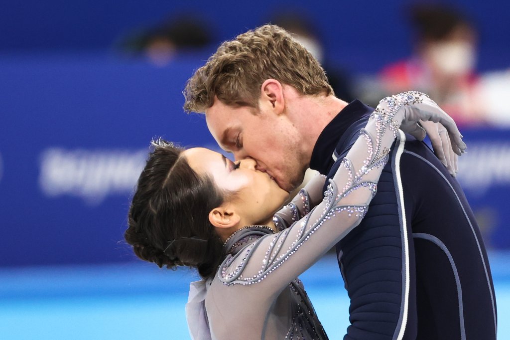 Ice dancers and real-life couple Madison Chock and Evan Bates of the USA share a kiss during the free dance event of the team figure skating competition at the 2022 Winter Olympic Games, at the Capital Indoor Stadium.