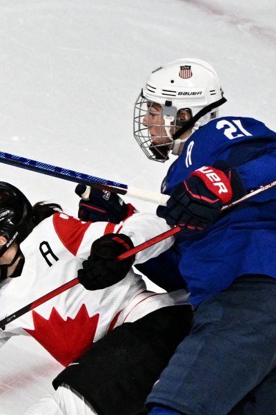 USA women and canada battle for puck