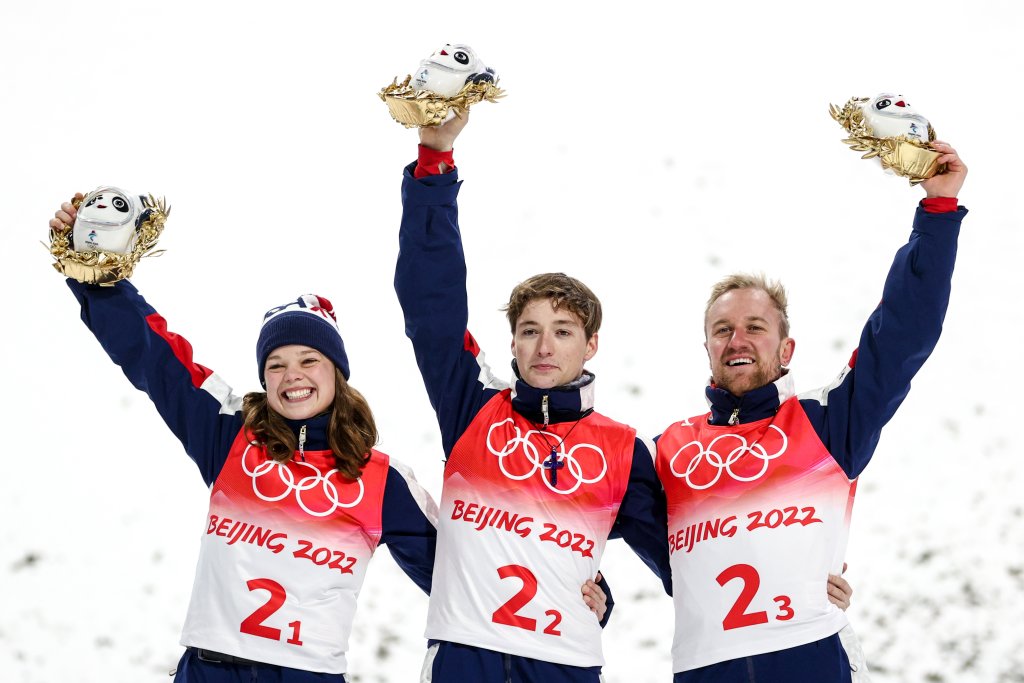 Team USA's Ashley Caldwell, Christopher Lillis and Justin Schoenefeld celebrate gold after the mixed team aerial skiing event at the Genting Snow Park as part of the 2022 Winter Olympic Games.