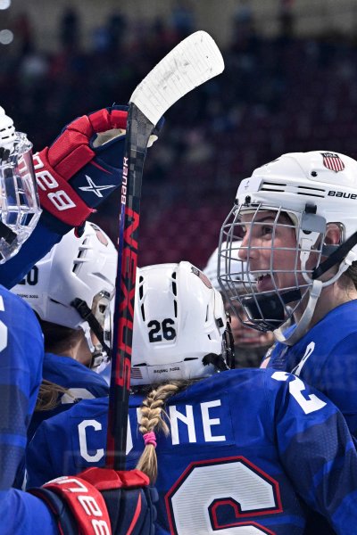 USA's players celebrate a goal scored by USA's Kendall Coyne Schofield (C) during the women's play-offs quarterfinals match of the Beijing 2022 Winter Olympic Games ice hockey competition