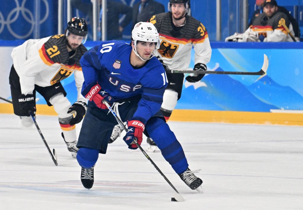 Team USA's Matty Beniers carries the puck during the men's preliminary round at the 2022 Winter Olympic Games ice hockey competition between USA and Germany, Feb. 13, 2022. 