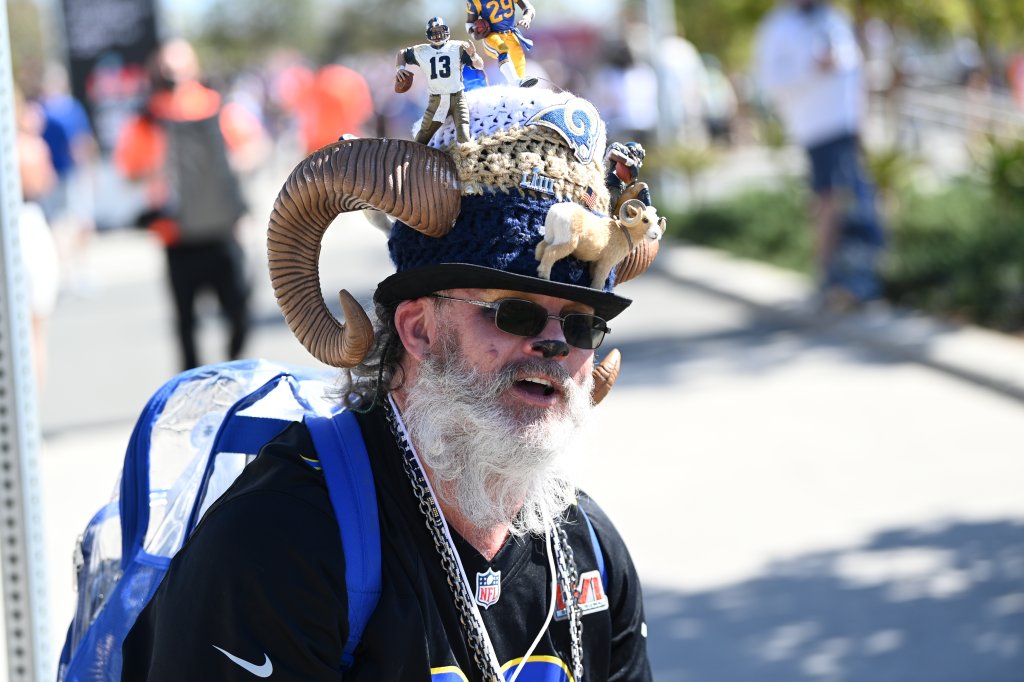 A Rams fan with a highly decorated hat poses 