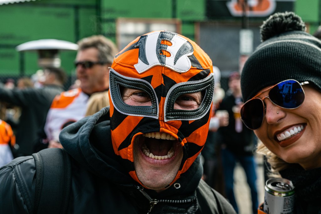 A masked Bengal fan looks on