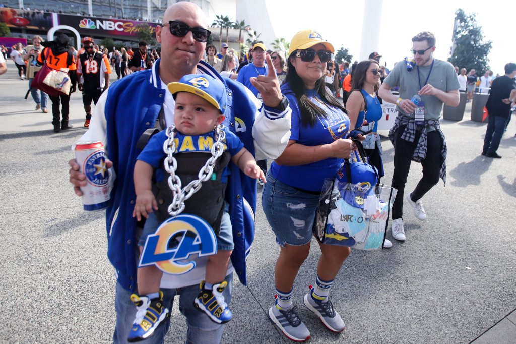 A Rams fan walks with his baby