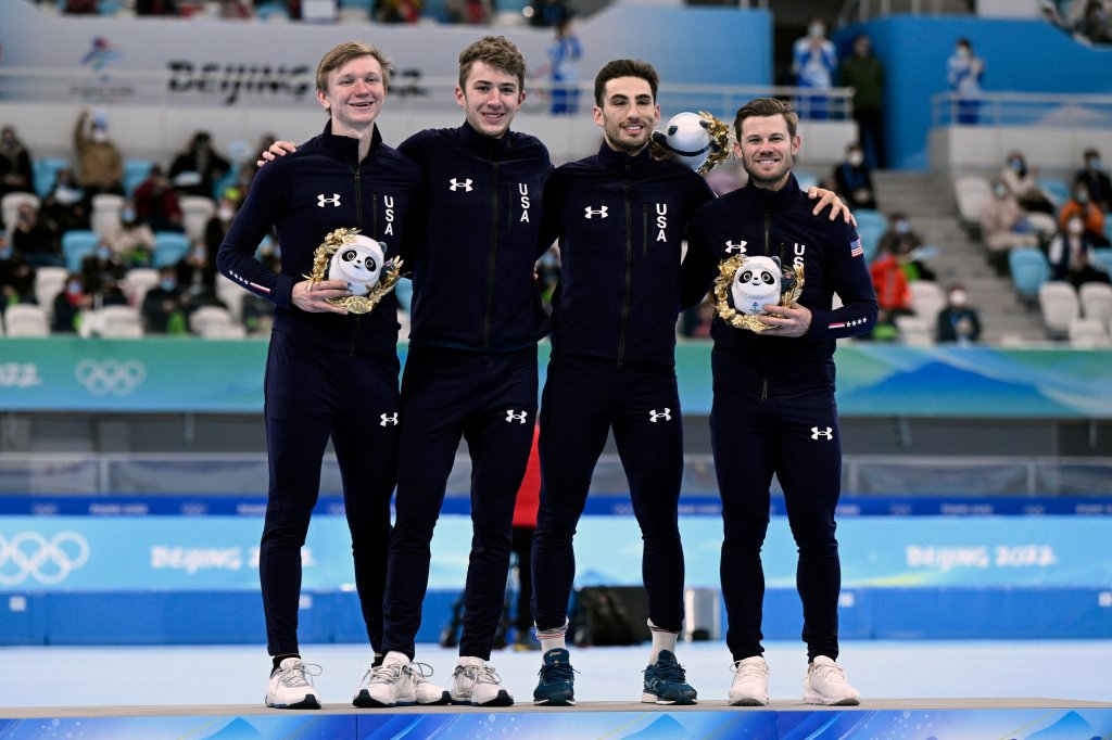 Team USA bronze medallists celebrate during the venue ceremony for the men's speed skating team pursuit