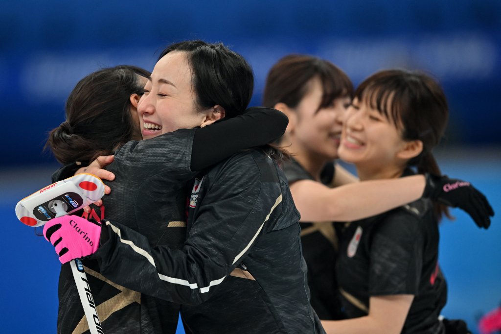 Yurika Yoshida, Satsuki Fujisawa, Chinami Yoshida and Yumi Suzuki celebrate their win during the 2022 Winter Olympic Games curling competition between USA and Japan at the National Aquatics Centre, Beijing, Feb. 16, 2022.