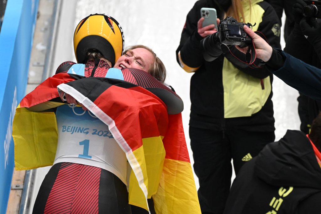 Team Germany's Natalie Geisenberger, gold medallist, and Anna Berreiter, silver medallist, celebrate during the Women's Singles Luge