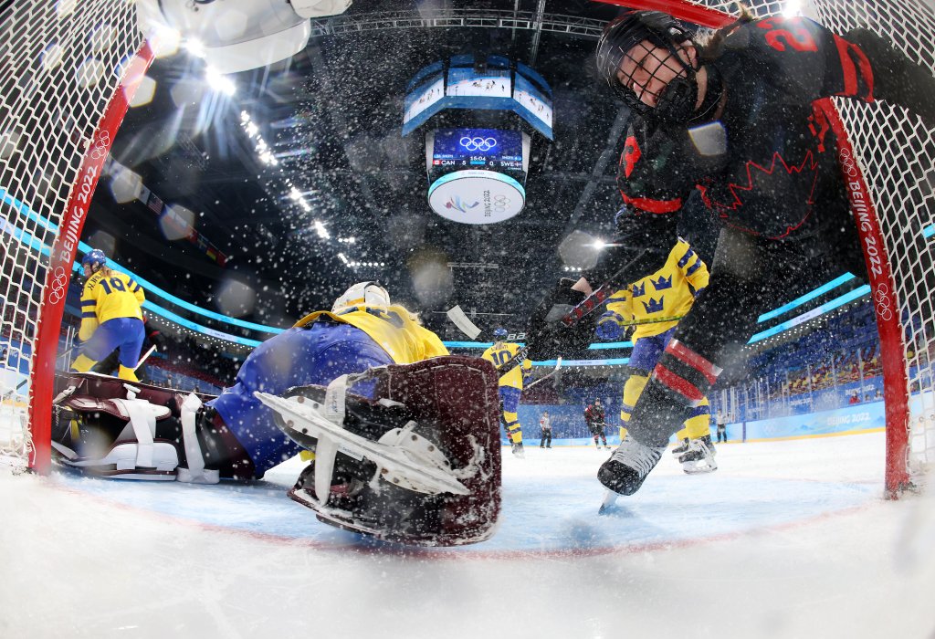 Defender Erin Ambrose #23 of Team Canada collides with goalkeeper Emma Soderberg #30 of Team Sweden in the second period during the Women's Ice Hockey Quarterfinal match at the 2022 Winter Olympic Games at Wukesong Sports Centre, Feb. 11, 2022 in Beijing. 