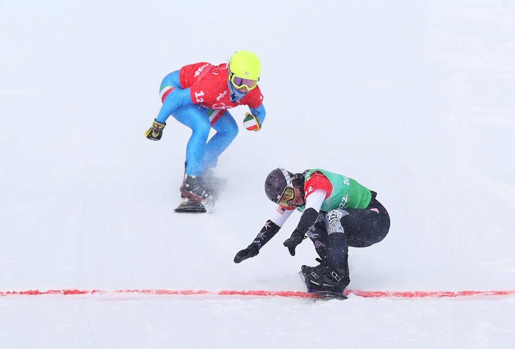 Lindsey Jacobellis of Team United States (R) and Michela Moioli of Team Italy (L) cross the finish line during the Snowboard Mixed Team Cross Big Final on day 8 of the 2022 Winter Olympics at Genting Snow Park on Feb. 12, 2022, in Zhangjiakou, China.