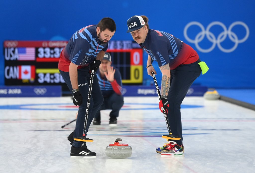 (L-R) John Landsteiner, John Shuster and Matt Hamilton of Team United States compete during the Men's Curling Round Robin Session against Team Canada on day 9 of the 2022 Winter Olympics at National Aquatics Centre on Feb. 13, 2022, in Beijing, China.