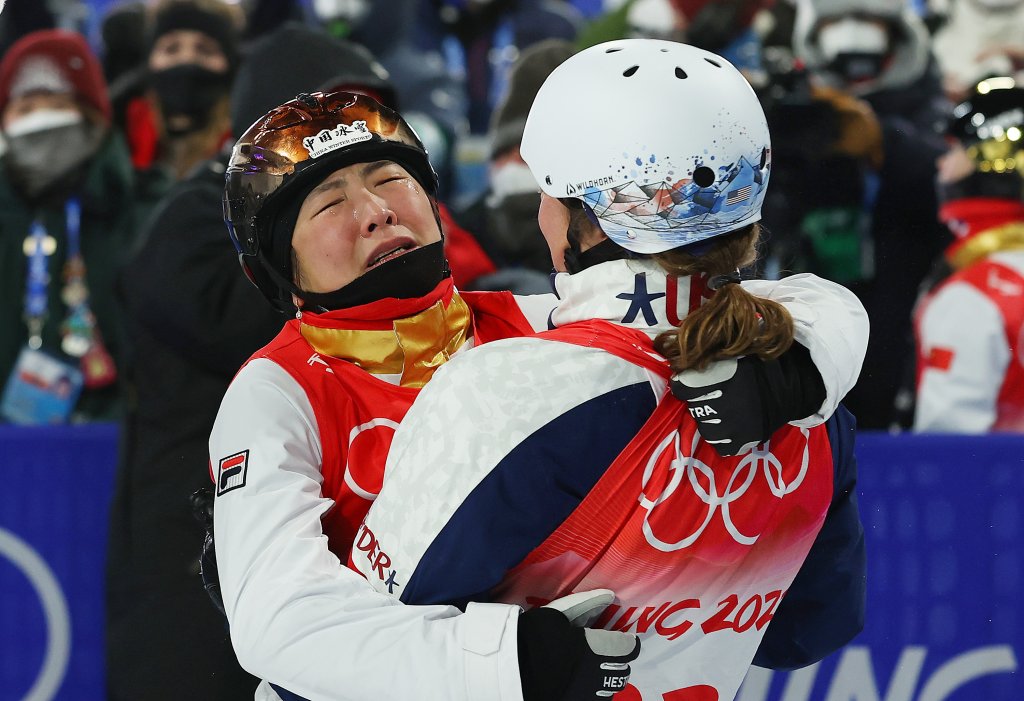 Gold medallist Xu Mengtao of Team China is embraced by Ashley Caldwell of Team United States