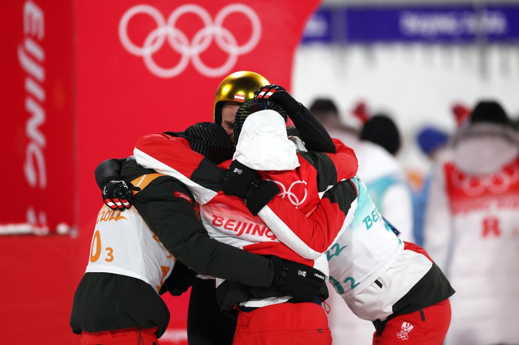 Team Austria celebrates after winning the Gold medal in the Men's Ski jumping