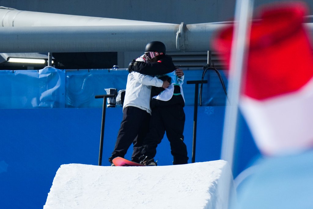 Su Yiming of Team China hugs his coach Yasuhiro Sato during the Men's Snowboard Big Air final on day 11 of the Winter Olympics at Big Air Shougang on Feb. 15, 2022, in Beijing, China.