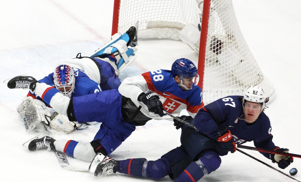 Martin Gernat #28 of Team Slovakia competes for control of the puck with Matt Knies #67 of Team United States during the Men’s Ice Hockey quarterfinal match at the 2022 Winter Olympic Games, Feb. 16, 2022, in Beijing.