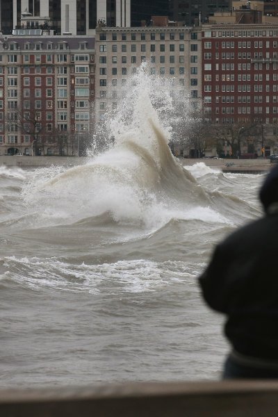 A man watches waves generated from the remnants Hurricane Sandy as they crash into the shoreline of Lake Michigan on October 30, 2012 in Chicago, Illinois.