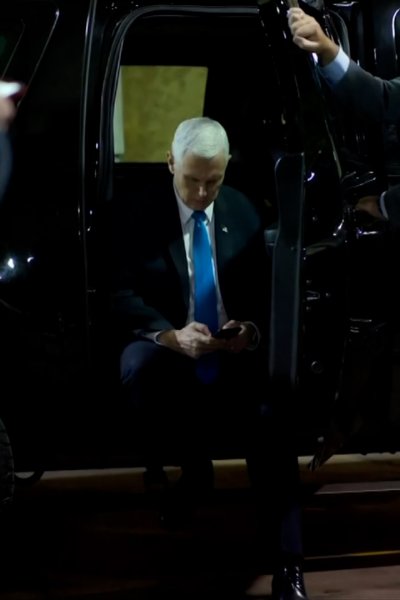 National archive photo of Mike Pence sitting on edge of car during Capitol riot